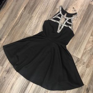 Black diamond encrusted cocktail dress.